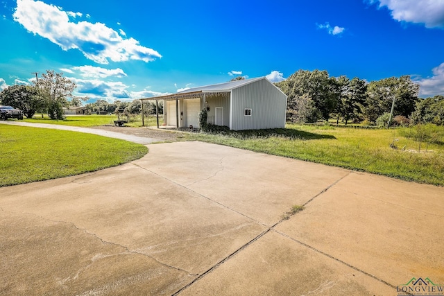 exterior space with a garage and a yard