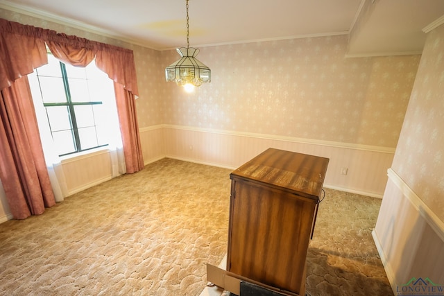 unfurnished dining area featuring crown molding, light carpet, and a chandelier