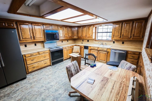 kitchen with electric range, dishwasher, sink, and fridge