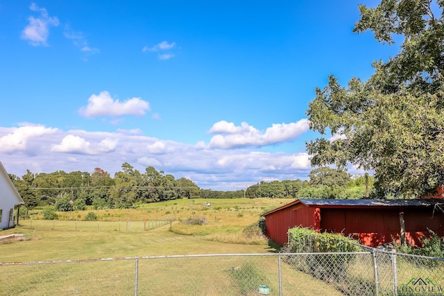 view of yard with an outbuilding and a rural view