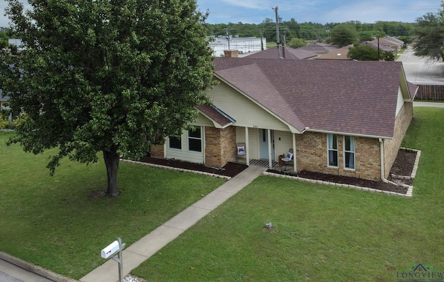 144 Hollie Cir, Sulphur Springs, TX 75482 - ranch-style home featuring brick siding, a shingled roof, covered porch, and a front yard