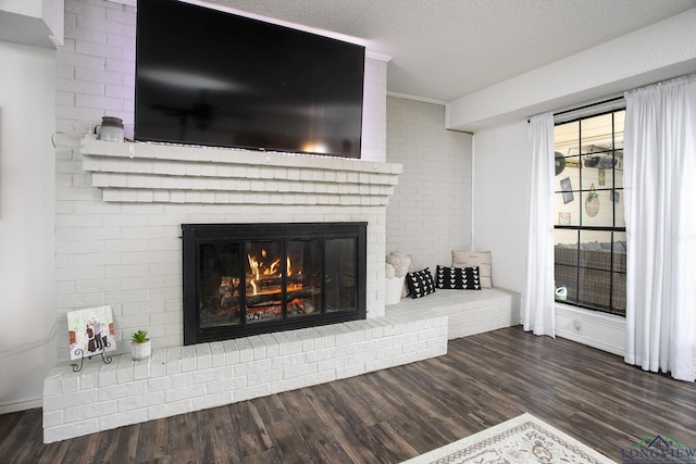 144 Hollie Cir, Sulphur Springs, TX 75482 - detailed view of a fireplace, wood finished floors, and a textured ceiling