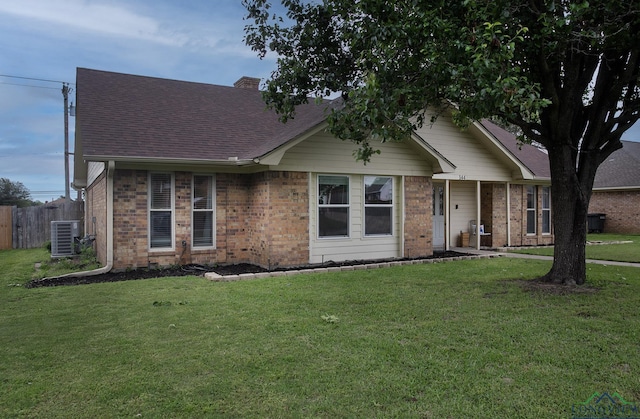 144 Hollie Cir, Sulphur Springs, TX 75482 - ranch-style house featuring central air condition unit, a shingled roof, brick siding, and a chimney