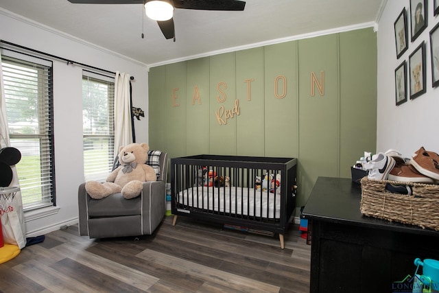 144 Hollie Cir, Sulphur Springs, TX 75482 - bedroom featuring ornamental molding, dark wood-style floors, a crib, ceiling fan, and baseboards