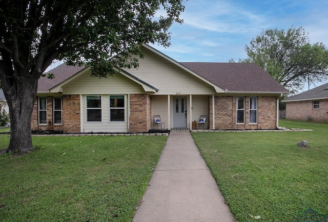 144 Hollie Cir, Sulphur Springs, TX 75482 - ranch-style house with a front lawn, brick siding, and roof with shingles