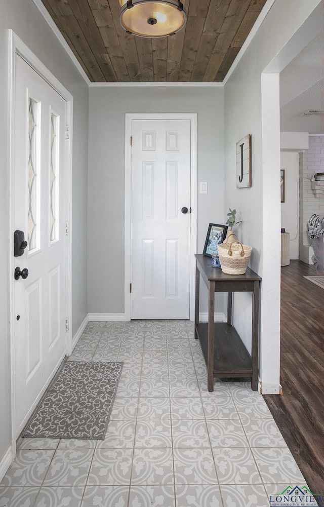144 Hollie Cir, Sulphur Springs, TX 75482 - foyer entrance with crown molding, wooden ceiling, and baseboards