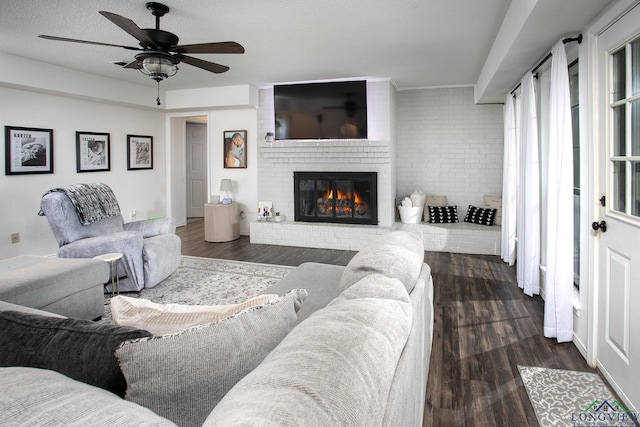 144 Hollie Cir, Sulphur Springs, TX 75482 - living area featuring dark wood-type flooring, a brick fireplace, and a ceiling fan