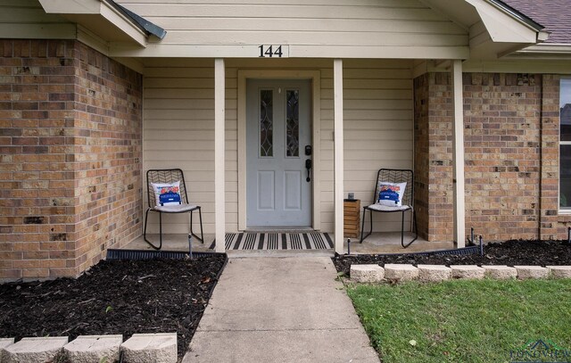 144 Hollie Cir, Sulphur Springs, TX 75482 - property entrance with a porch and brick siding