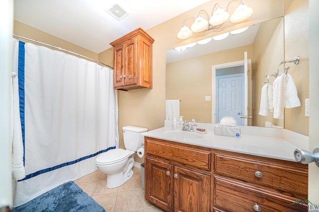 bathroom featuring tile patterned flooring, vanity, and toilet