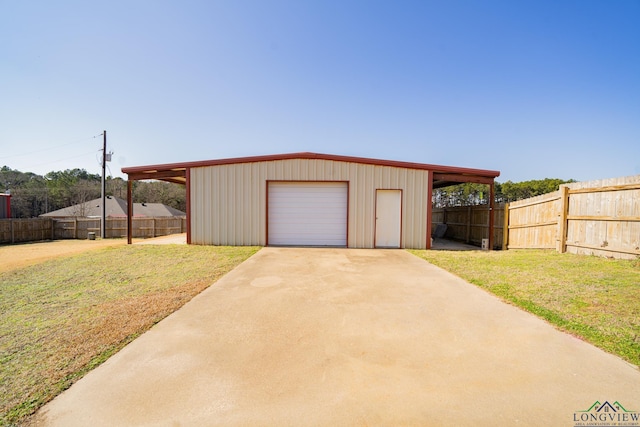 garage featuring a carport and a lawn