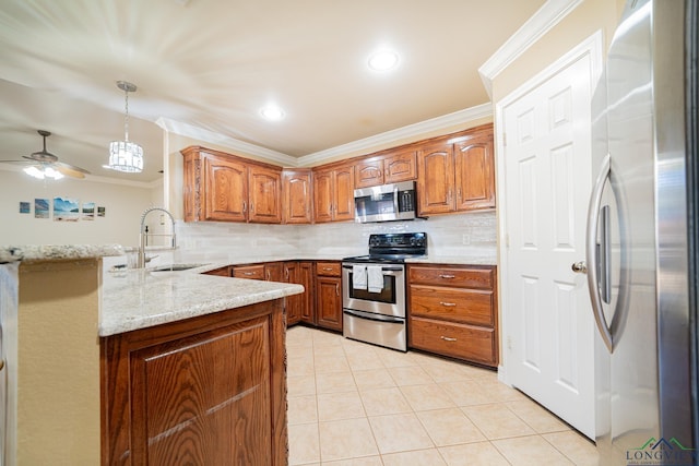 kitchen with appliances with stainless steel finishes, sink, hanging light fixtures, light stone counters, and kitchen peninsula