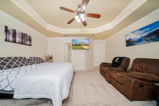 carpeted bedroom featuring a raised ceiling, crown molding, and ceiling fan