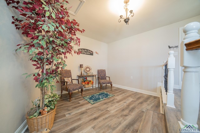 sitting room with baseboards and wood finished floors