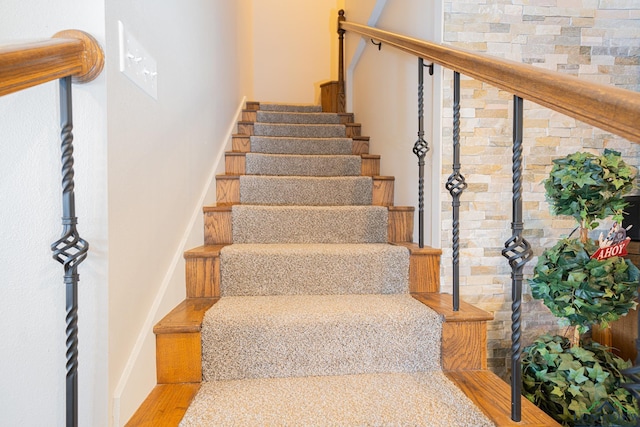 staircase with wood finished floors