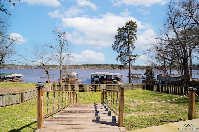 exterior space with a yard, a boat dock, and a water view