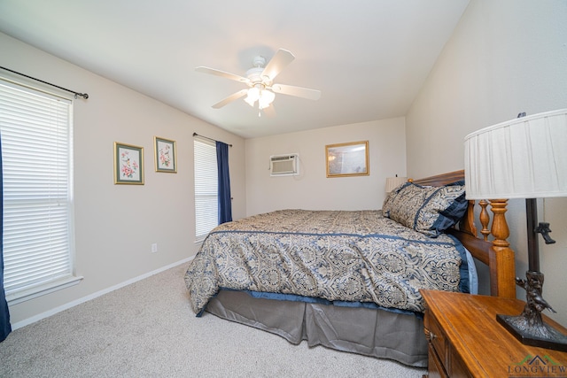 bedroom featuring multiple windows, carpet, ceiling fan, and a wall unit AC