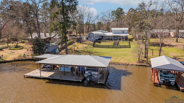 dock area featuring a lawn, a water view, and boat lift