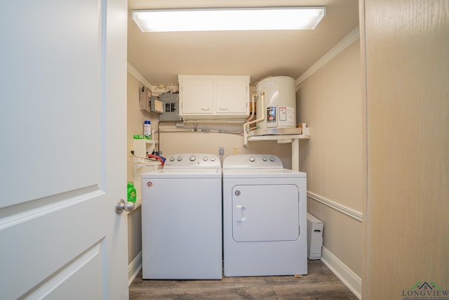 laundry room with wood finished floors, baseboards, cabinet space, crown molding, and washer and clothes dryer