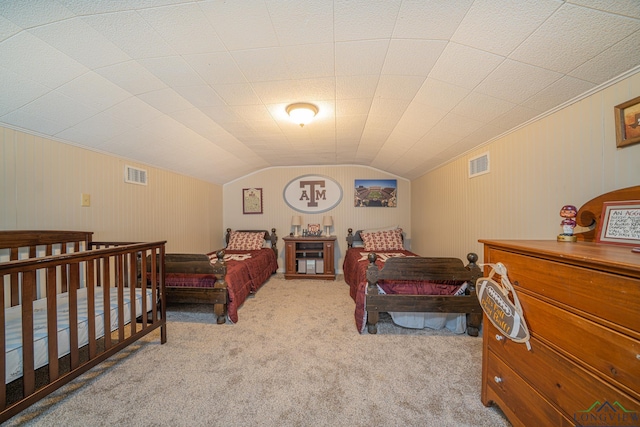 bedroom featuring vaulted ceiling, carpet flooring, and visible vents