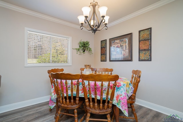 dining area featuring a notable chandelier, crown molding, baseboards, and wood finished floors