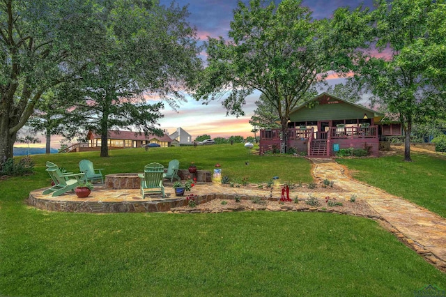 209 Rocky Point Rd, Mount Vernon, TX 75457 - yard at dusk with an outdoor fire pit, a yard, stairway, and a patio area