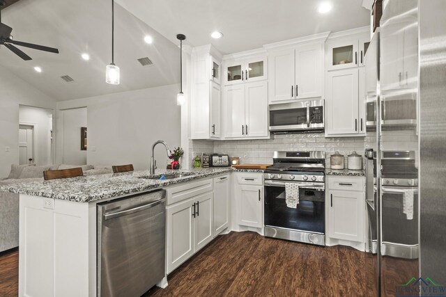 kitchen featuring decorative light fixtures, stainless steel appliances, white cabinetry, and sink