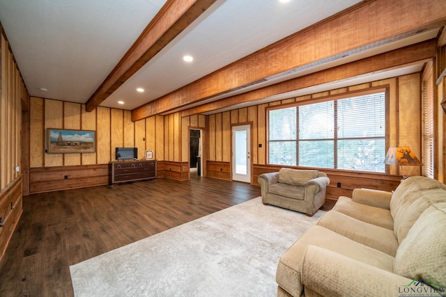 living room featuring wooden walls, beam ceiling, and dark hardwood / wood-style flooring