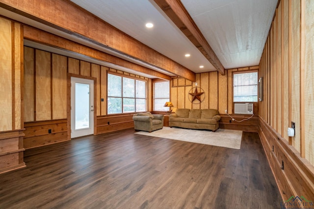 unfurnished room featuring dark wood-type flooring, a wealth of natural light, and beam ceiling