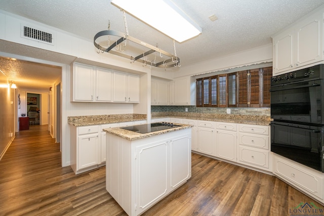 kitchen with black appliances, a kitchen island, white cabinets, and dark wood-type flooring