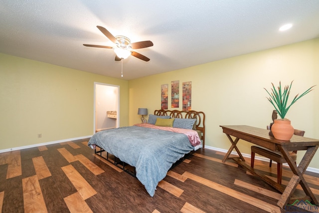 bedroom featuring a ceiling fan, baseboards, dark wood finished floors, and a textured ceiling