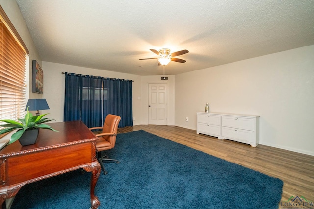 office space with ceiling fan, hardwood / wood-style floors, and a textured ceiling