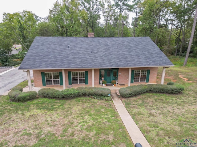 view of front of home featuring covered porch and a front lawn