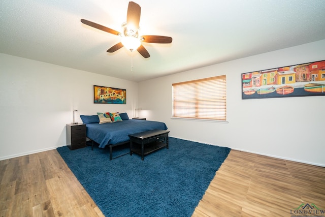 bedroom featuring hardwood / wood-style flooring and ceiling fan