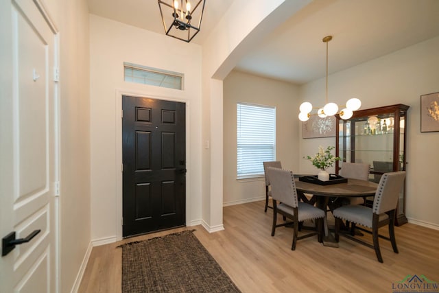 dining room featuring light hardwood / wood-style floors and a notable chandelier