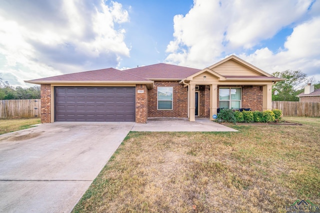 single story home with a garage and a front lawn