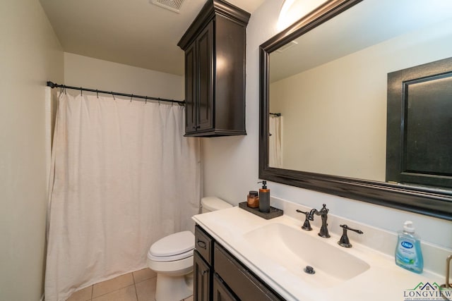 bathroom with tile patterned floors, vanity, and toilet