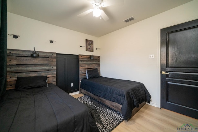 bedroom with ceiling fan and light hardwood / wood-style flooring