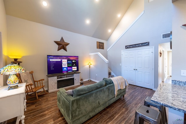 living room with high vaulted ceiling and dark hardwood / wood-style floors