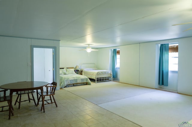 carpeted bedroom with multiple windows and ceiling fan