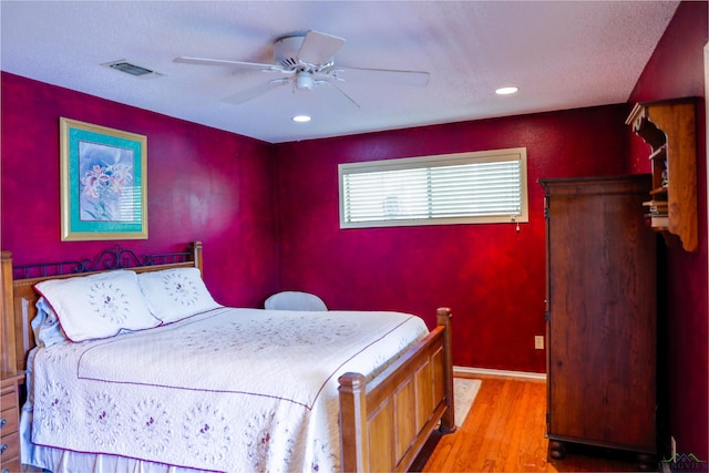 bedroom with hardwood / wood-style flooring and ceiling fan