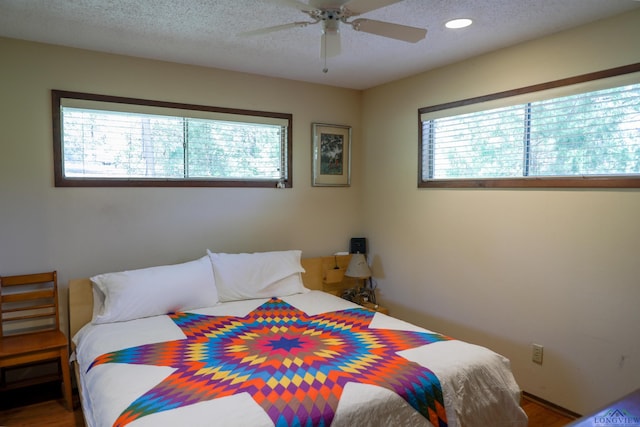 bedroom featuring ceiling fan and a textured ceiling