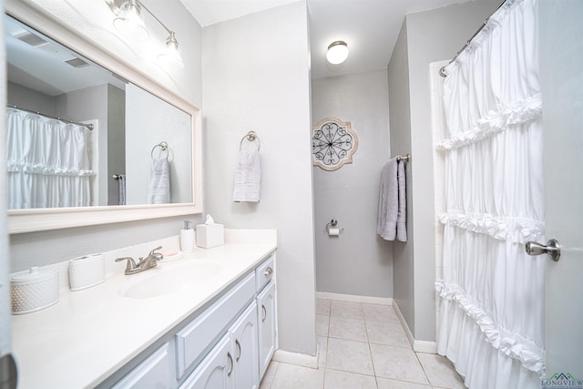 bathroom with tile patterned floors and vanity