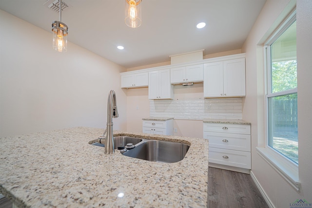 kitchen featuring white cabinetry, sink, decorative backsplash, and decorative light fixtures