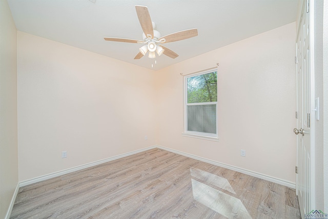 spare room featuring light hardwood / wood-style flooring and ceiling fan