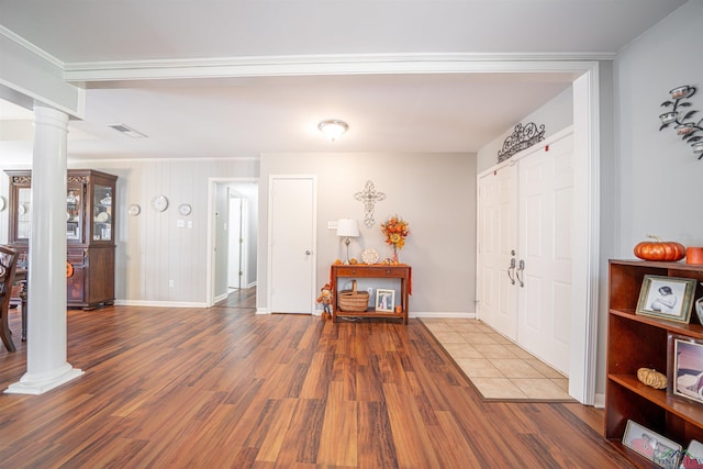 foyer with wood-type flooring and ornate columns