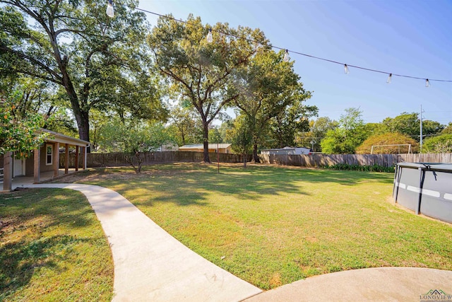 view of yard with a covered pool