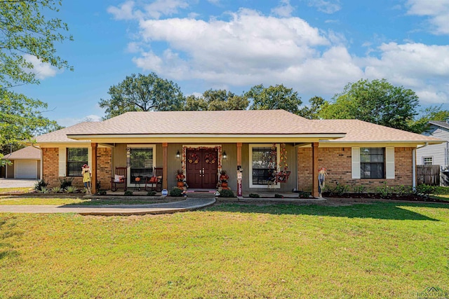 ranch-style home featuring a garage, a front yard, and a porch