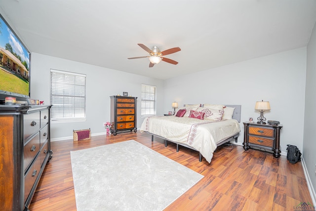 bedroom featuring ceiling fan and dark hardwood / wood-style floors