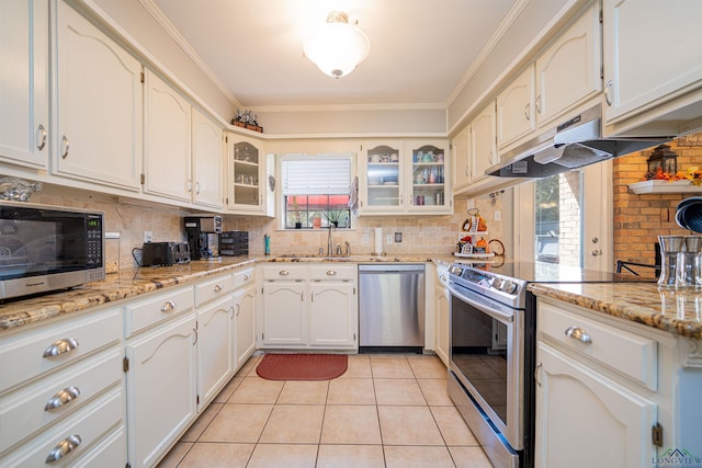 kitchen featuring tasteful backsplash, sink, light tile patterned floors, stainless steel appliances, and light stone countertops