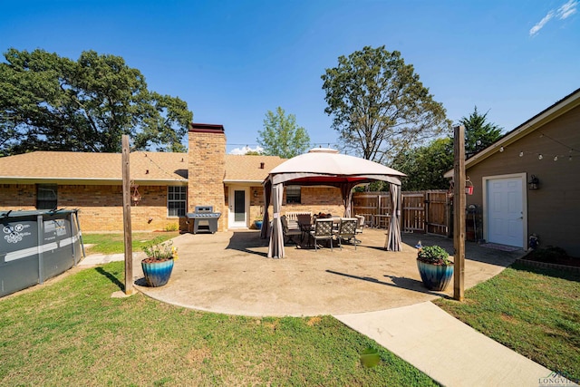 exterior space with a gazebo and grilling area